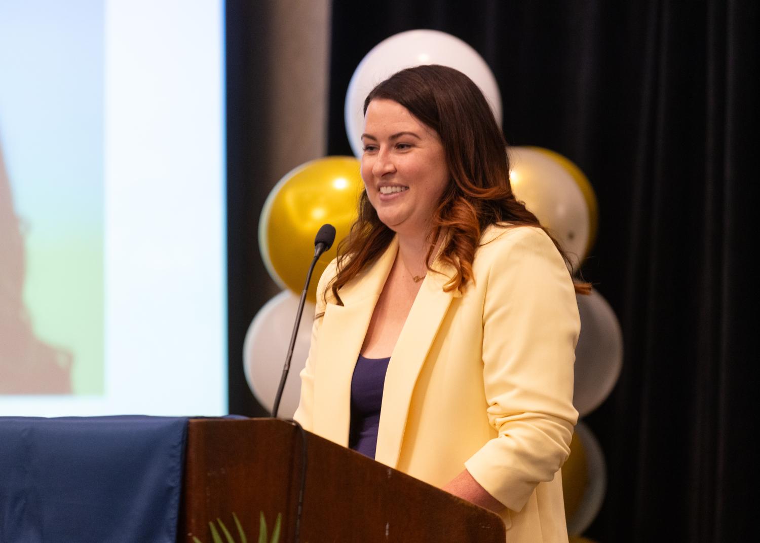Dr. Courtnee Ambos giving graduation speech.