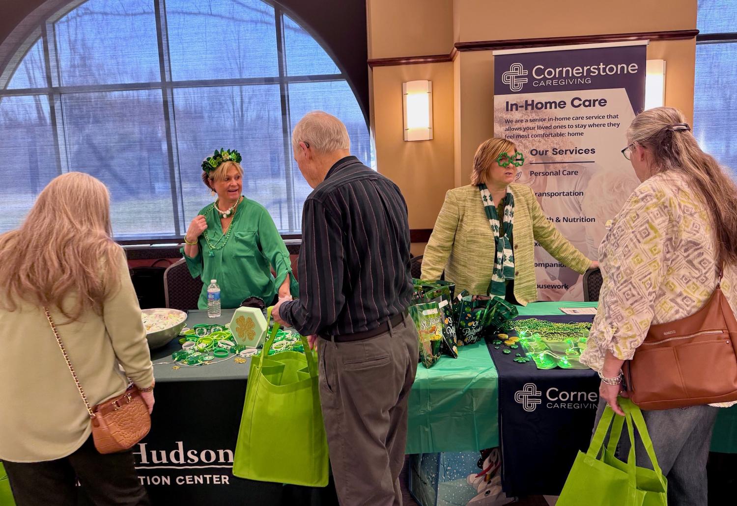 senior coalition members wearing green talk to seniors in attendance at the Luck of the Irish Luncheon at Cuyahoga Falls Natatorium