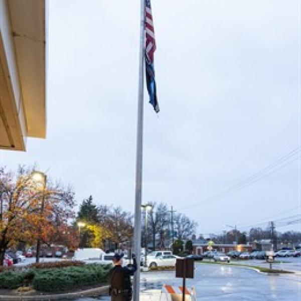 John Howe, Security, raises the flag to begin service